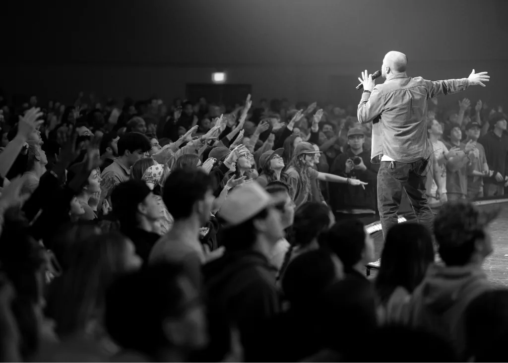 Worship leader with hands raised